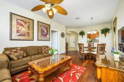a living room with a couch and a table at Epic Universe Vista Cay Deluxe Condo, Near the Parks! - 3006 in Orlando