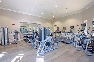 a gym with several treadmills and cardio machines at Vista Cay Deluxe Condo, Vista Cay - 3010 in Orlando