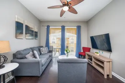 a living room with a couch and a ceiling fan at Beautiful Deluxe Condo, Vista Cay - 3024 in Orlando
