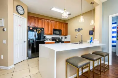 a kitchen with a white counter and a refrigerator at Beautiful Modern Condo, Near the Parks! - 3021 in Orlando