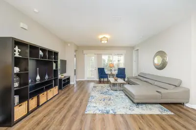 a living room with a couch and a table at Epic Universe Vacation Condo, Vista Cay - 2017 in Orlando
