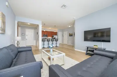 a living room with two blue couches and a tv at Epic Universe New Listing! Lakeview Condo, Vista Cay - 1017 in Orlando