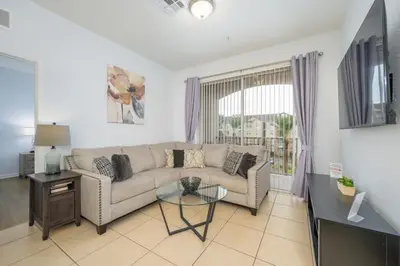 a living room with a couch and a table at New Listing Beautiful Condo, Vista Cay - 3017 in Orlando
