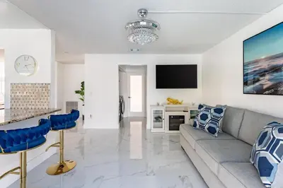 a living room with a couch and a tv at Villa Resort Club in Kissimmee
