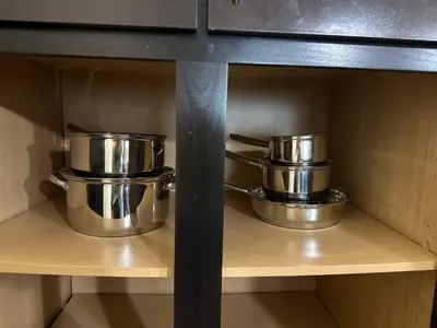 two pots and pans on a shelf in a kitchen at Orlando Bliss Near Disney in Orlando