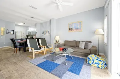 a living room with a couch and a table at Encantada Resort 10 minutes to Disney w/ Pool in Kissimmee