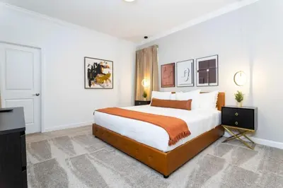 a bedroom with a large bed and a television at Casa 5Q c/ Piscina e Temas da Disney in Kissimmee