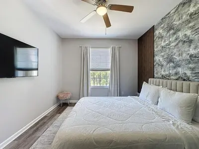 a bedroom with a bed and a ceiling fan at Beautiful Three bed condo, Minutes from Disney condo in Kissimmee