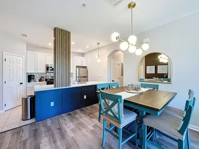 a kitchen and dining room with a table and chairs at Beautiful Three bed condo, Minutes from Disney condo in Kissimmee