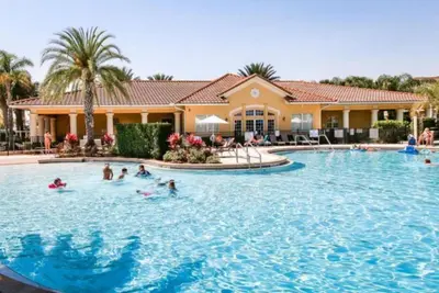 a group of people in the swimming pool at a resort at Oakwater Fountain View 3BR Home, Pool, By Disney in Orlando