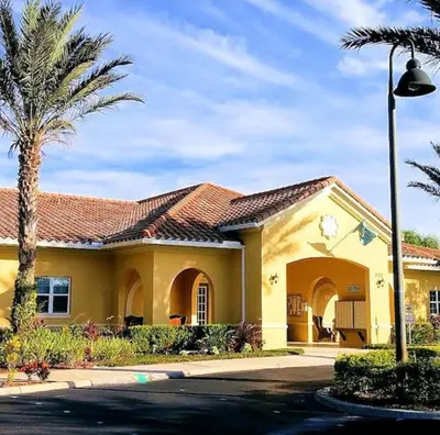 a yellow house with a palm tree in front of it at Oakwater Fountain View 3BR Home, Pool, By Disney in Orlando