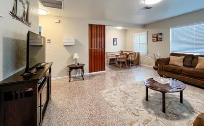 a living room with a couch and a tv at Downtown Duplex B Private Yard Great Location in Sanford