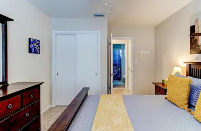 a bedroom with a bed and a dresser and a door at Downtown Duplex B Private Yard Great Location in Sanford