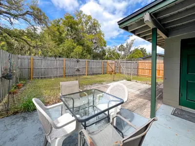 a patio with a table and chairs and a fence at Downtown Duplex B Private Yard Great Location in Sanford