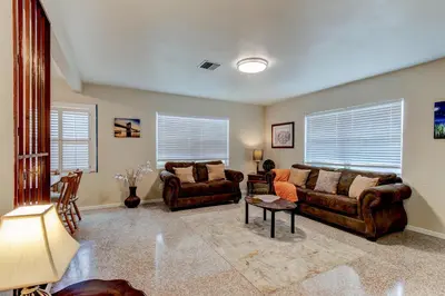 a living room with two couches and a table at Downtown Duplex B Private Yard Great Location in Sanford