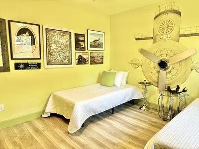 a bedroom with a bed and a clock on the wall at Happy Palette Home Close to downtown Fenced yard in Sanford