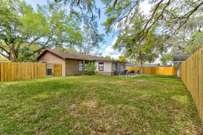 a home with a fence and a yard at Happy Palette Home Close to downtown Fenced yard in Sanford