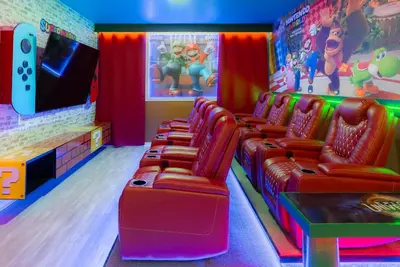 a game room with red chairs and a nintendo wii at Brand New Home 8 BedroomsPoolSleeps 26 in Kissimmee