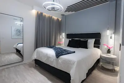 a bedroom with a large bed and a mirror at Brand New Home 8 BedroomsPoolSleeps 26 in Kissimmee