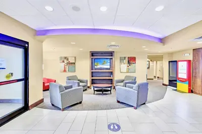a waiting room at a hospital with chairs and tables at Studio near Universal Studios w Games & BBQ in Orlando