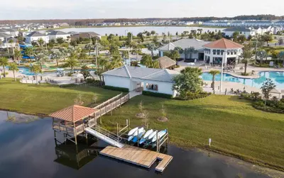 an aerial view of a home with a dock at Cozy & Stylish 2BR Condo Prime Storey Lake Spot in Kissimmee