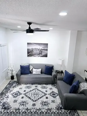 a living room with a couch and a ceiling fan at Casa Maria- A piece of Heaven in Kissimmee
