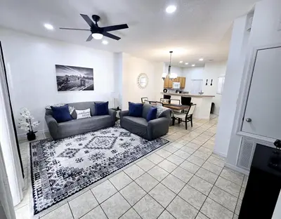 a living room with a couch and a dining room at Casa Maria- A piece of Heaven in Kissimmee