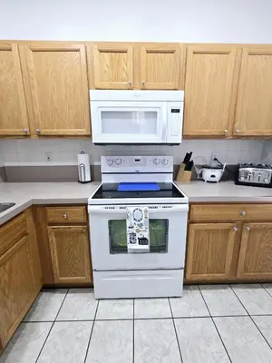 a kitchen with a white stove and a microwave at Casa Maria- A piece of Heaven in Kissimmee