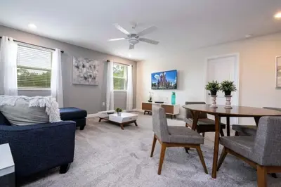 a living room with a couch and a table at Villa 6Q Disney Style c/ Piscina e Game Room in Kissimmee