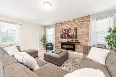 a living room with a couch and a fireplace at Villa 6Q Disney Style c/ Piscina e Game Room in Kissimmee