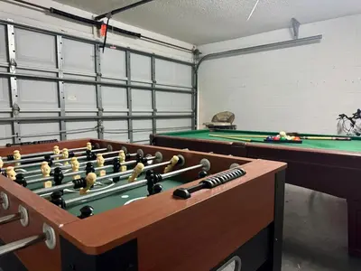 a room with two pool tables and snooker at 4701-Lake Berkley villa- Renovated 3 bed in Kissimmee