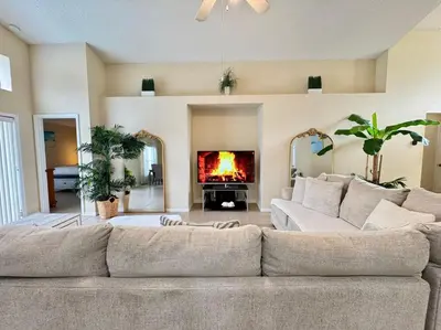 a living room with a couch and a fireplace at 4701-Lake Berkley villa- Renovated 3 bed in Kissimmee