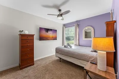 a bedroom with a bed and a dresser and a window at Disney-Area Kissimmee 3BR | Community Pool in Kissimmee