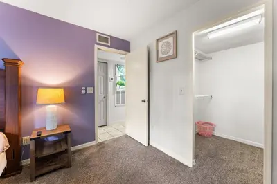 a bedroom with purple walls and an open door at Disney-Area Kissimmee 3BR | Community Pool in Kissimmee