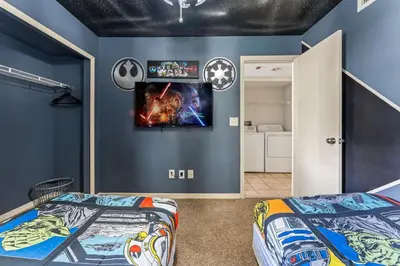 a bedroom with two beds and a tv on the wall at Disney-Area Kissimmee 3BR | Community Pool in Kissimmee