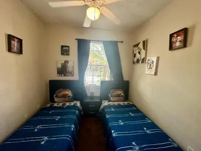 a bedroom with two twin beds and a window at Grand Panoramic 3BR Townhouse Near Disney Parks in Kissimmee