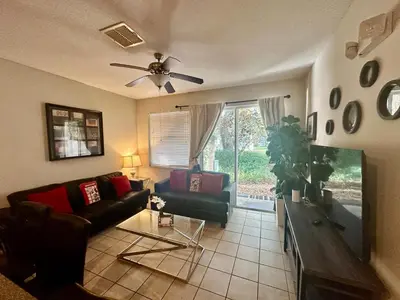 a living room with a couch and a ceiling fan at Grand Panoramic 3BR Townhouse Near Disney Parks in Kissimmee