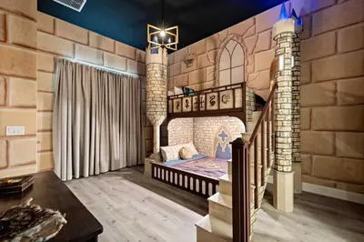 a castle themed bedroom with a bed in a brick wall at Grand 15-Bedroom Villa -Magical Themes Pool & Game Loft Lakeview in Kissimmee