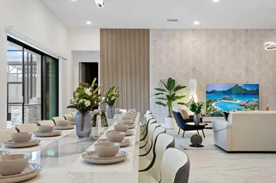 a long dining room with a long table and chairs at Grand 15-Bedroom Villa -Magical Themes Pool & Game Loft Lakeview in Kissimmee