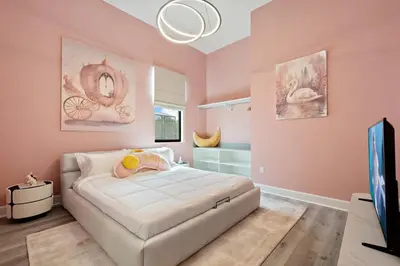 a bedroom with a white bed in a room with pink walls at Grand 15-Bedroom Villa -Magical Themes Pool & Game Loft Lakeview in Kissimmee