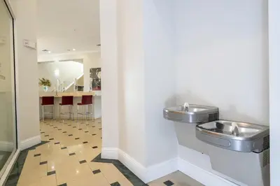 a bathroom with two stainless steel sinks on a wall at Near Universal Parks Cozy Apartament at The Point in Orlando