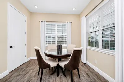 a dining room with a table and chairs at Waterfront Cottage With Balcony And Private Pool Near Disney And Margaritaville Resort & Island H20 Waterpark Access - 3008Ph in Orlando