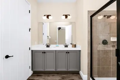 a bathroom with a sink and a shower at Waterfront Cottage With Balcony And Private Pool Near Disney And Margaritaville Resort & Island H20 Waterpark Access - 3008Ph in Orlando