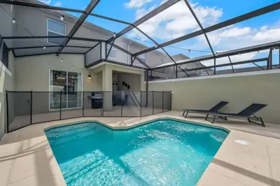 a swimming pool in the middle of a house at 2416 Luxo & Magia: Casa com Piscina no Storey Lake! in Kissimmee