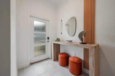 a bathroom with a vanity with a mirror and two stools at 2416 Luxo & Magia: Casa com Piscina no Storey Lake! in Kissimmee