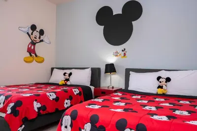 a bedroom with two beds with mickey mouse sheets at Spacious 4Bd Disney Dream with Resort Access at Lucaya 3210 in Kissimmee