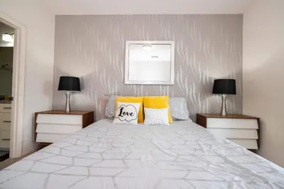 a bedroom with a large white bed with two night stands at Spacious 4Bd Disney Dream with Resort Access at Lucaya 3210 in Kissimmee
