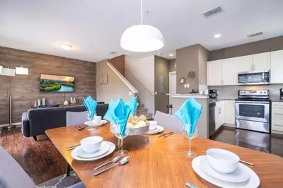 a kitchen and dining room with a wooden table with chairs at Spacious 4Bd Disney Dream with Resort Access at Lucaya 3210 in Kissimmee