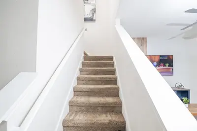 a staircase in a house with white walls at Stunning 3 bedroom 3 bath townhome 370 in Kissimmee