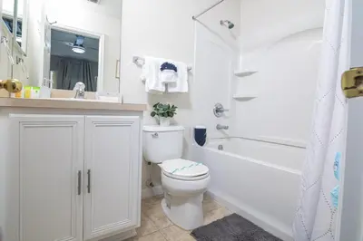 a white bathroom with a toilet and a tub and a sink at Stunning 3 bedroom 3 bath townhome 370 in Kissimmee